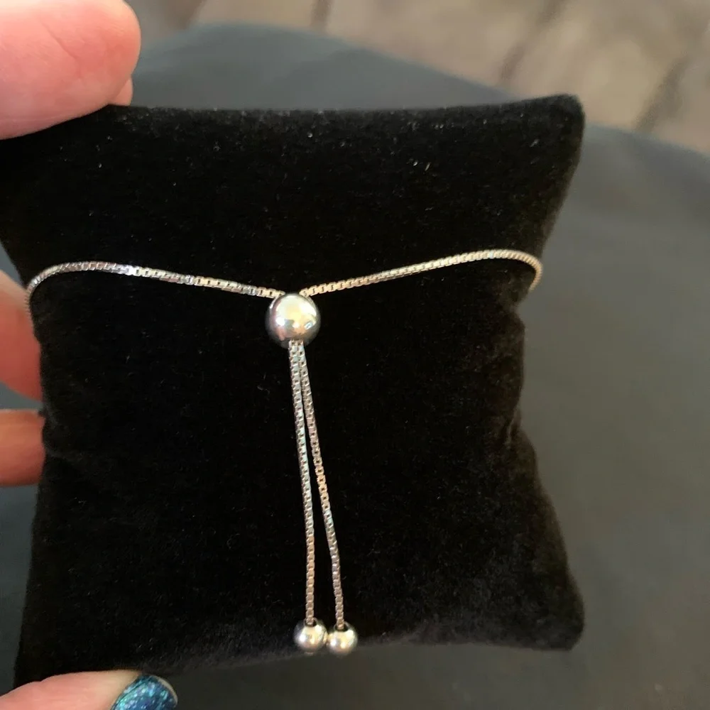Rhodium over sterling silver lab ruby heart bolo bracelet
